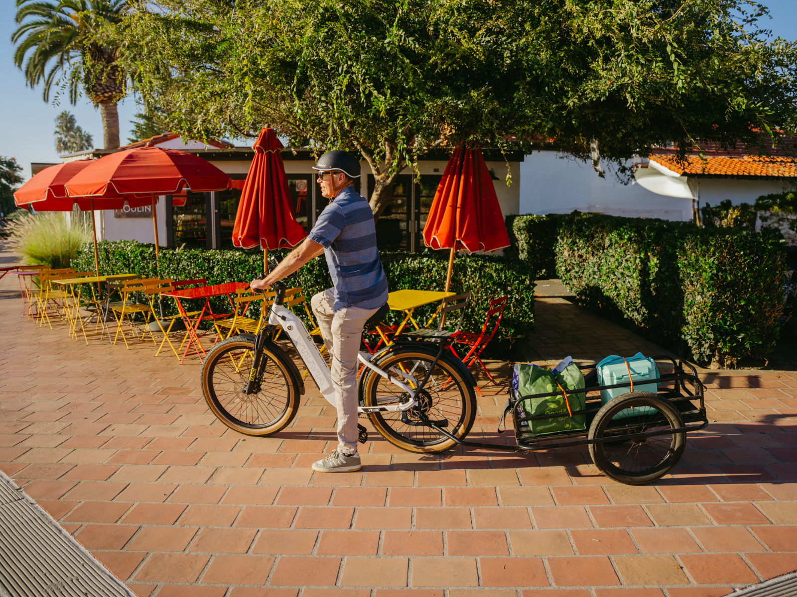Senior riding a VTUVIA Zeal XT8 electric bike with a cargo trailer on a grocery trip