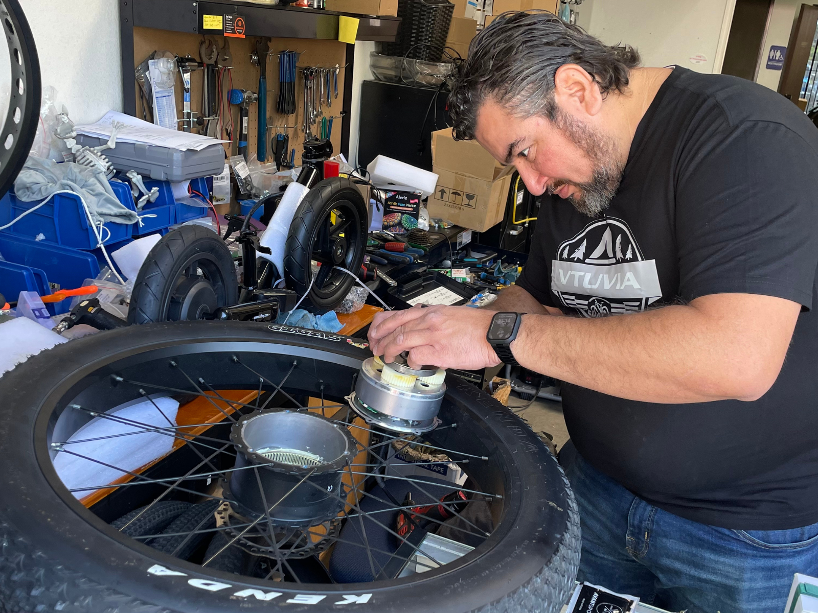 A technician repairing a VTUVIA electric bike in a workshop