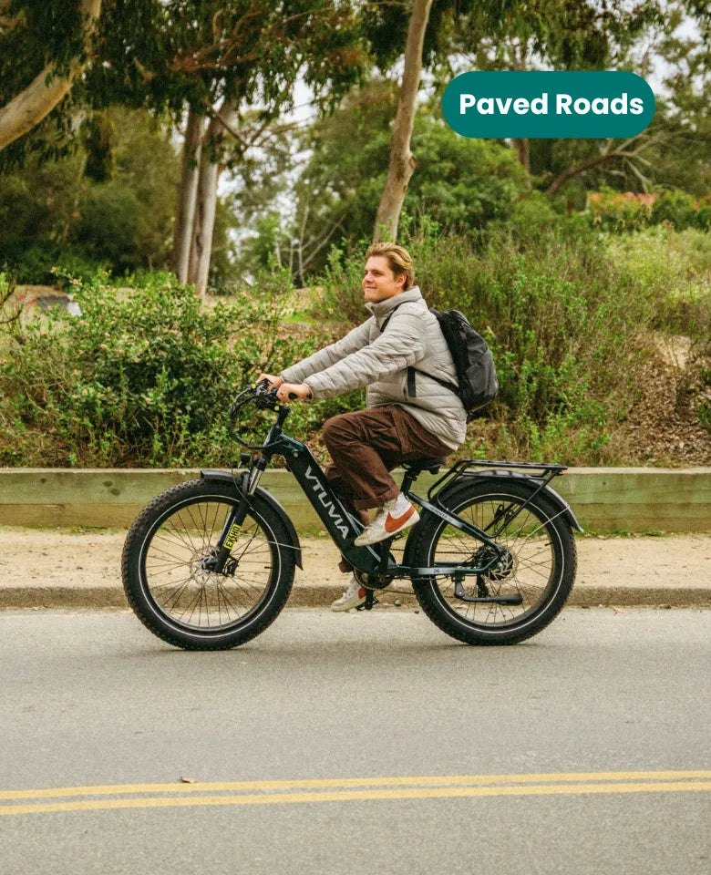 Rider on VTUVIA Reindeer 2.0 step-through fat tire ebike on paved road, casual neighborhood ride