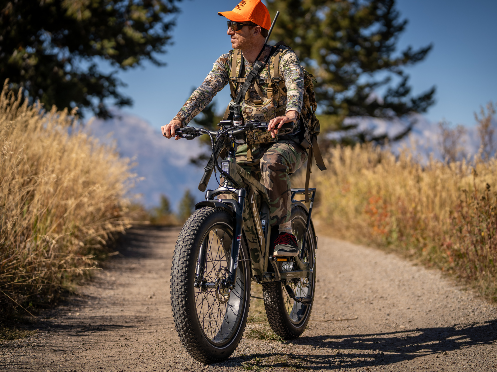 Hunter riding the VTUVIA SN100 electric bike while hunting