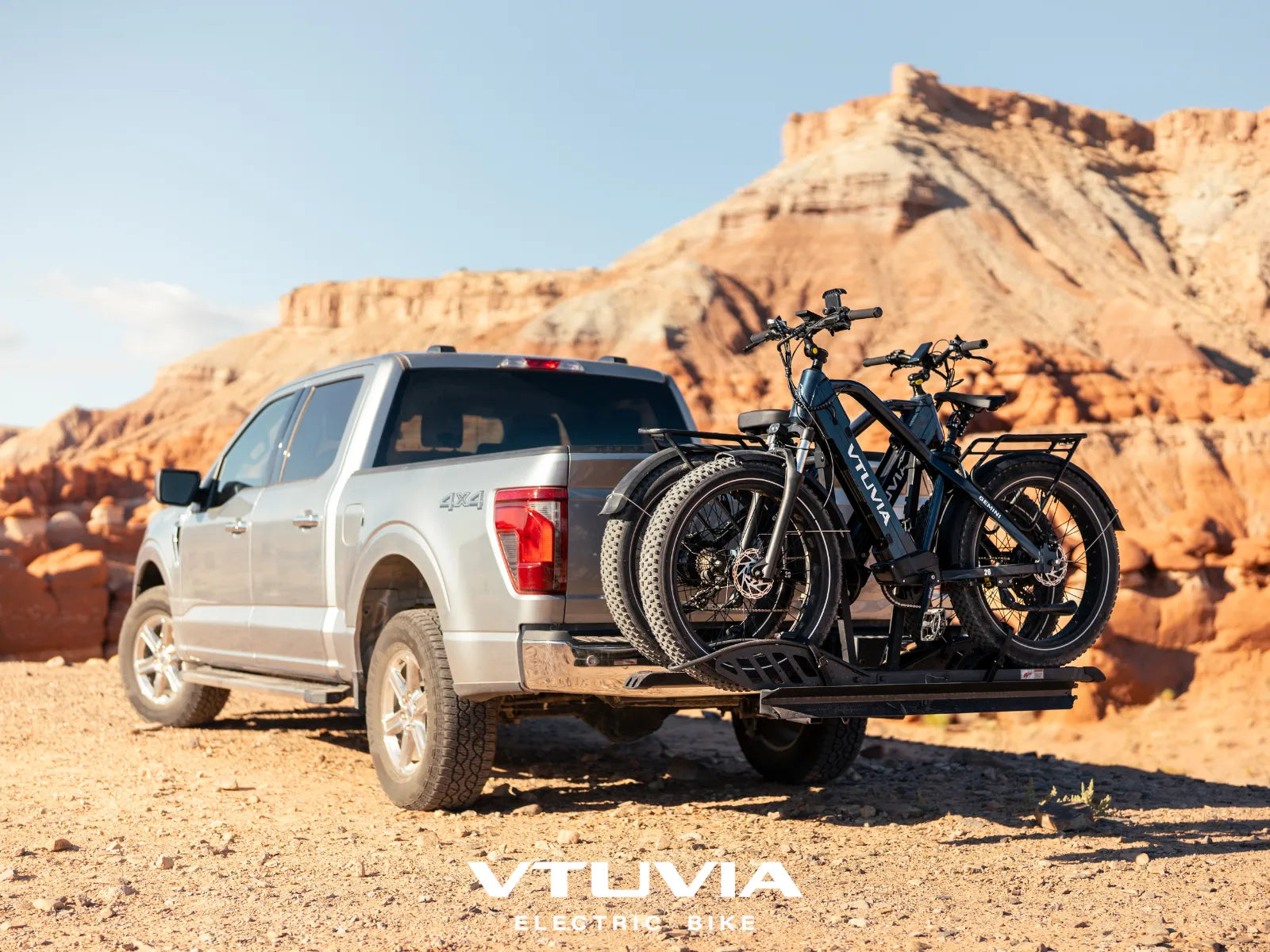 Two VTUVIA GEMINI electric bikes on a pickup truck rack.