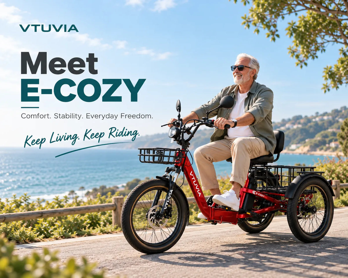 Older man riding a red VTUVIA E-COZY electric trike on a waterfront path