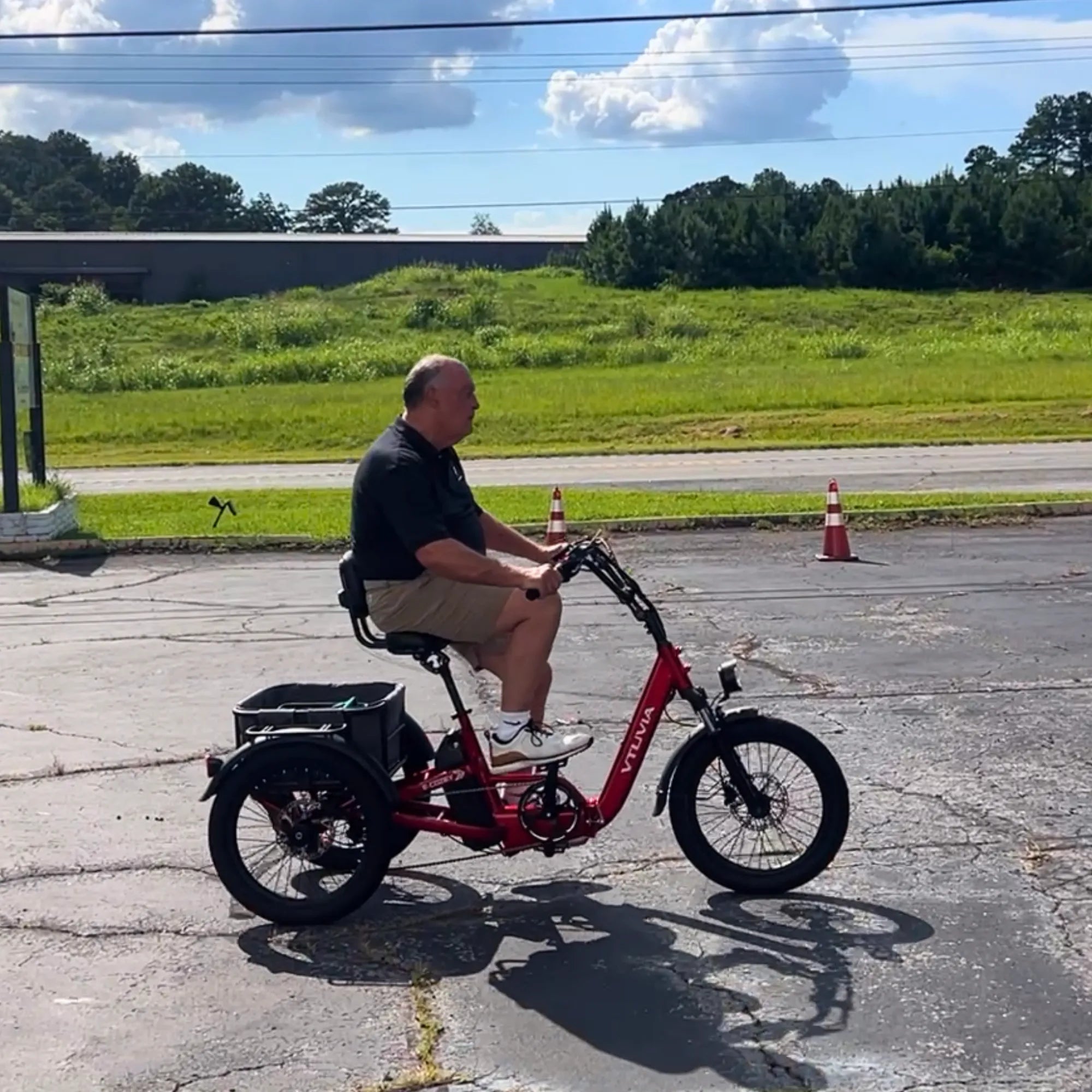 VTUVIA E-COZEY electric trike outdoor riding on a paved path with rider enjoying a comfortable three-wheel ride#color_ruby-red